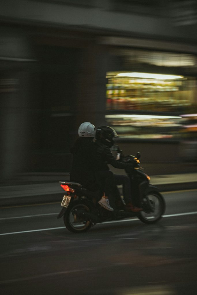 a-couple-of-people-ride-on-a-motorcycle-nyqmnjxb2ai a-couple-of-people-ride-on-a-motorcycle-nyqmnjxb2ai
