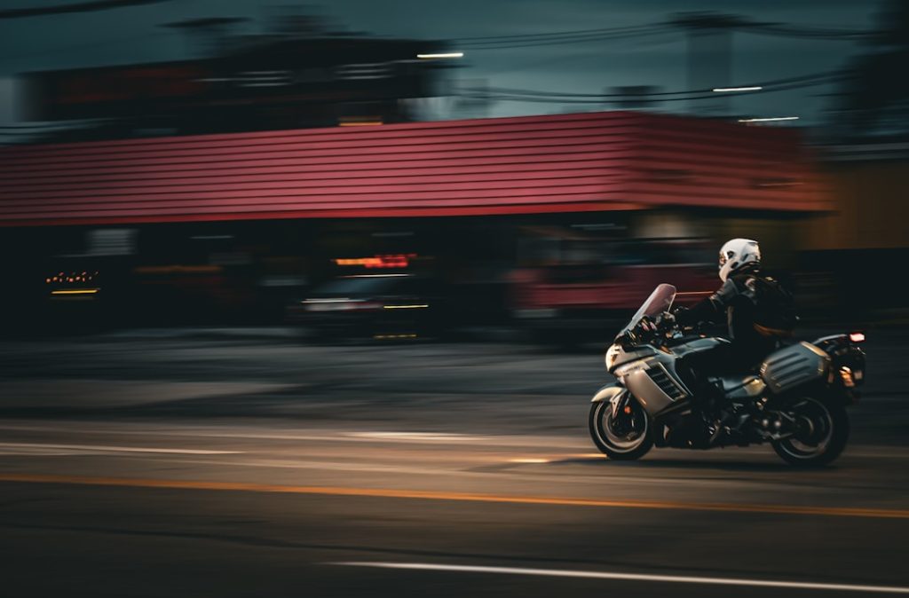 a-person-riding-a-motorcycle-on-a-city-street-n5-ttr8rw44 a-person-riding-a-motorcycle-on-a-city-street-n5-ttr8rw44