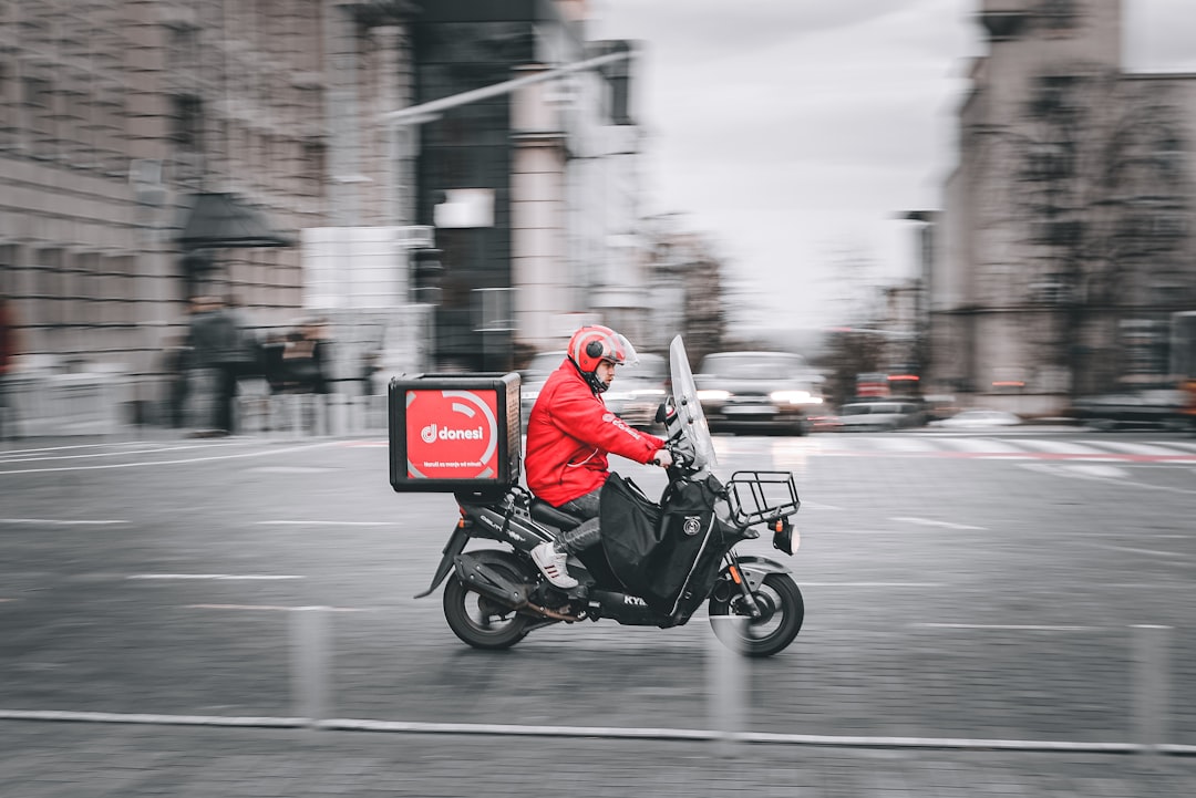 man-in-red-jacket-riding-motorcycle-on-road-during-daytime-fhlidpfgefg