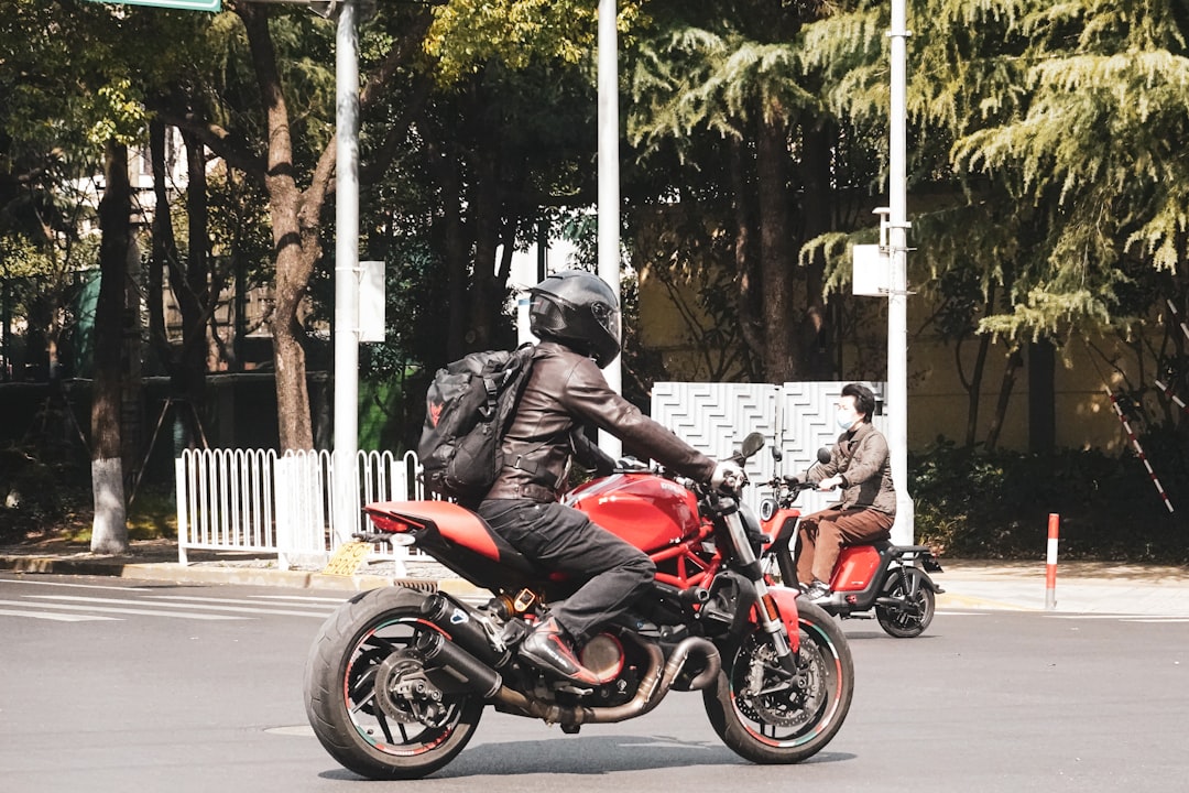 man-in-red-jacket-riding-red-motorcycle-on-road-during-daytime-fs-0hgpbbc